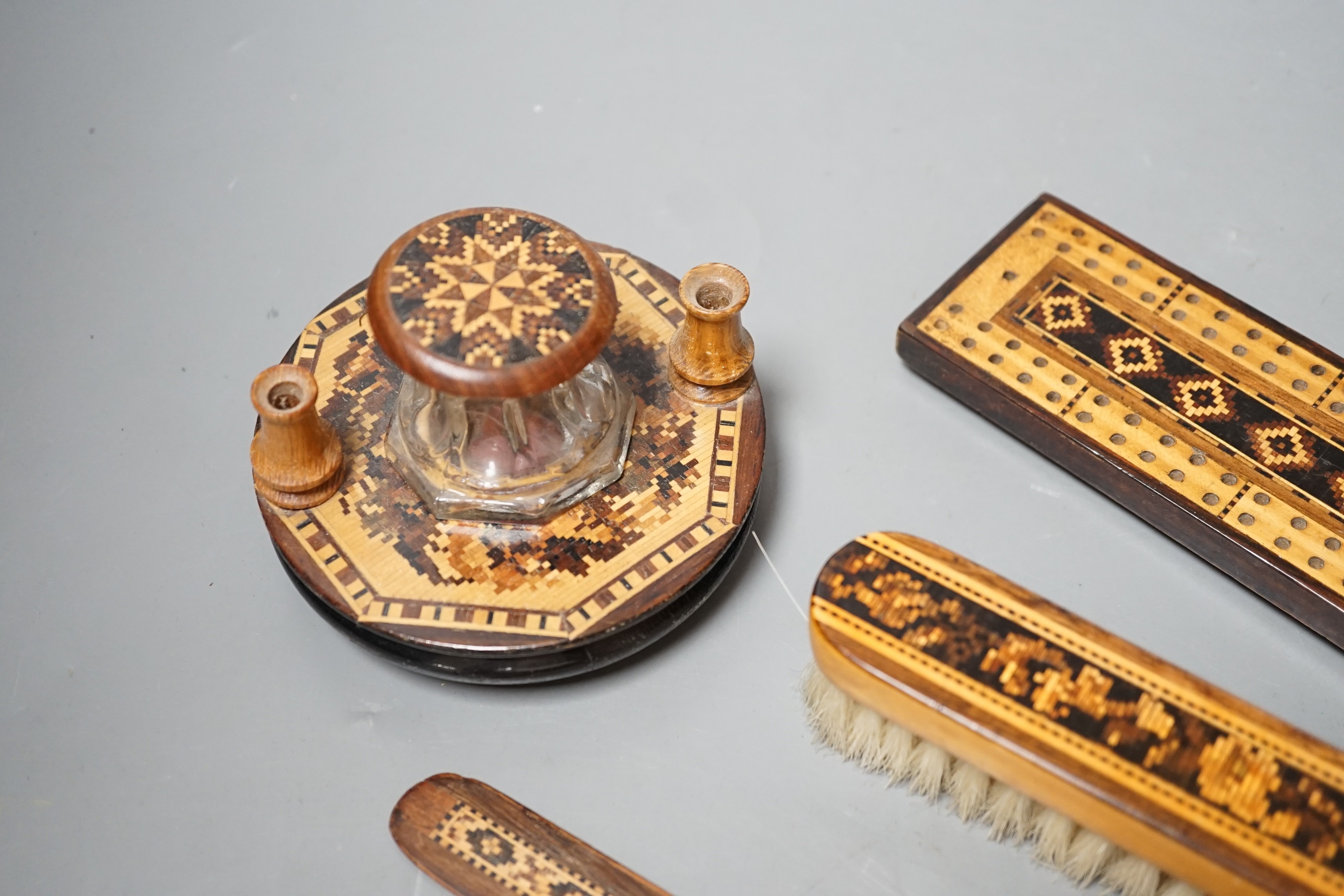 A group of Tunbridge ware to include an inkstand, two paper knives (one a handle only), cribbage board, a brush and a brooch